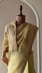 Lemon yellow saree on the mannequin, close view