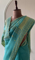 Teal saree on the mannequin, close view