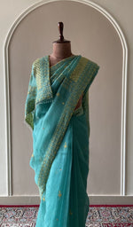 Embroidery on the teal saree, close view