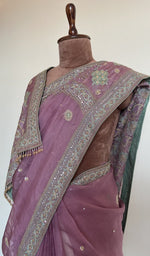 Fine do taar chikankari on border and palla on the mauve saree