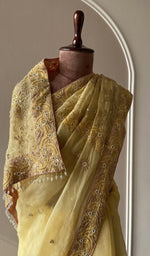 Lemon yellow saree on the mannequin, close view