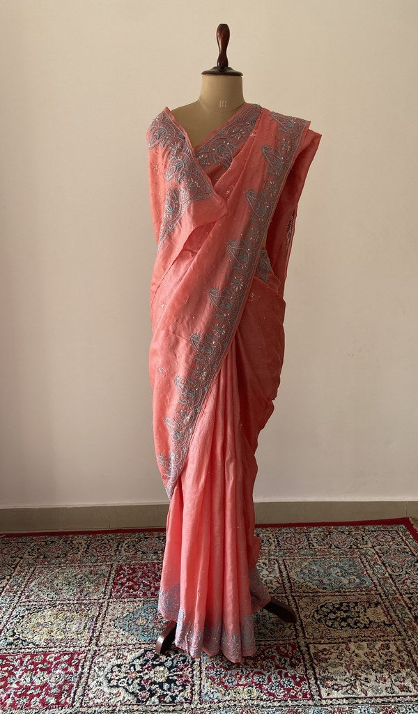 Coral pure tussar silk chikankari saree draped on the mannequin