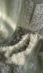 Sage green organza silk laid flat on the table
