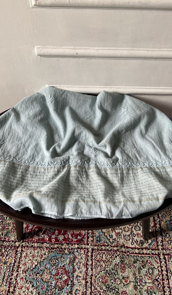 Chikankari across the body of the grey kurta piece