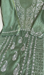 Sage green linen laid flat on the table