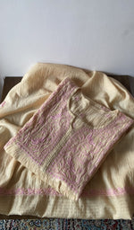 The kurta piece folded on the carpet