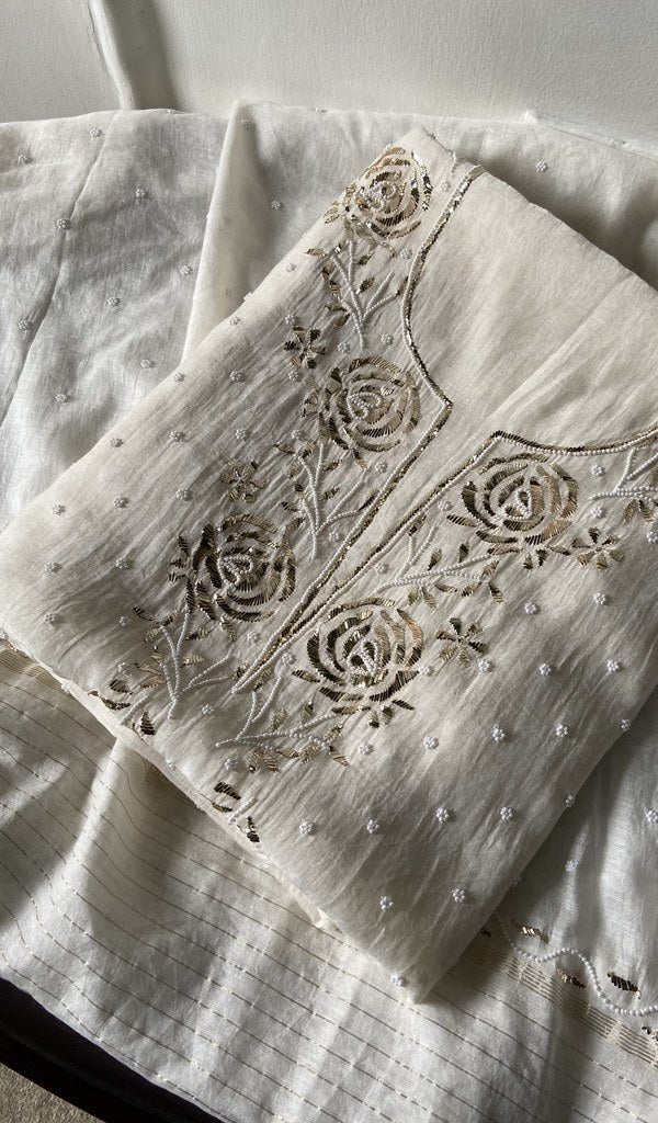 white pure mul chanderi kurta piece folded, badla work and beadwork