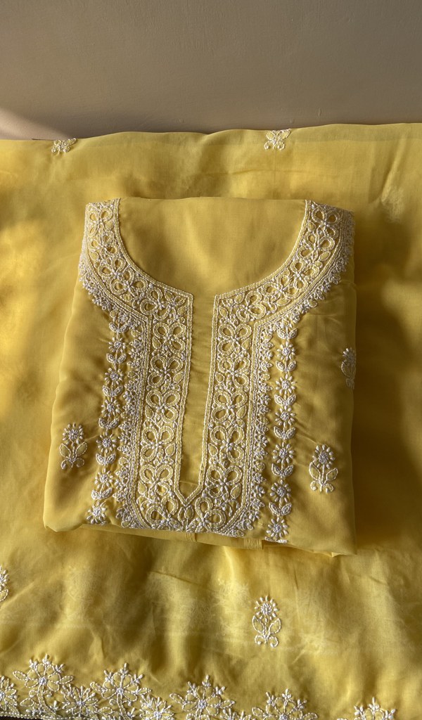 Folded yellow cotton kurta, front view