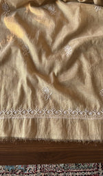 The beige kurta, spread out flat