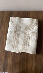 The cream kurta, spread out flat