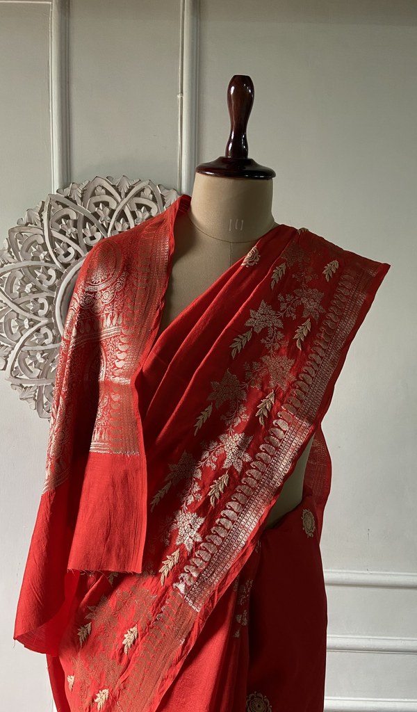 red pure silk chikankari saree draped on the mannequin