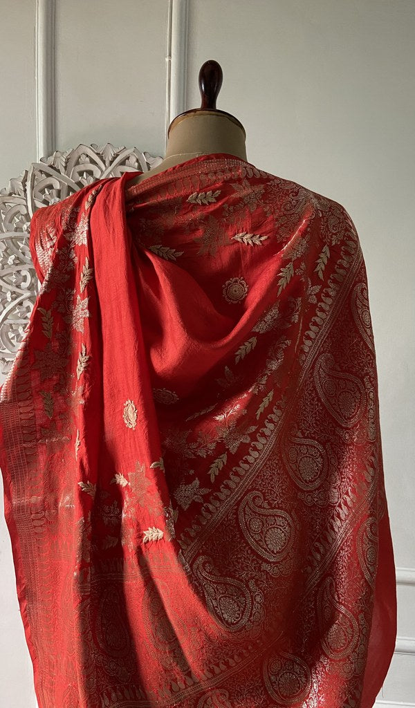 the saree in full, folded on the stool