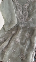 Sage grey organza silk laid out flat