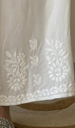 Chikankari at the hem of the white cotton palazzo, close up