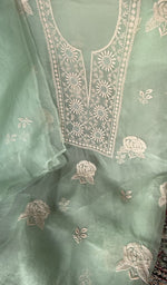 Motifs across the body of the green kurta