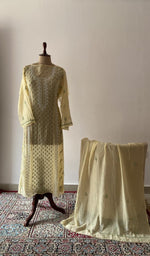 Yellow pure mul chanderi chikankari suit set on the mannequin with its dupatta