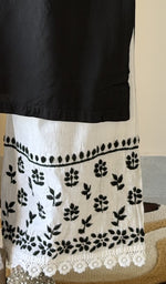 Chikankari at the hem of the white cotton palazzo, close up