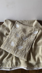 Folded beige pure mul chanderi kurta piece with chikankari on the panel
