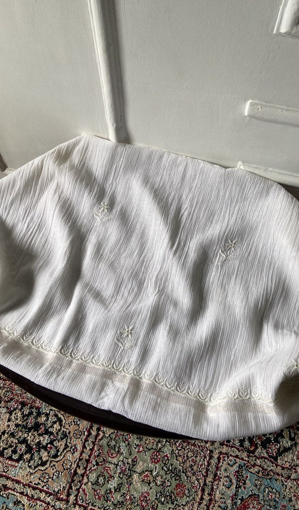 Chikankari across the body of the white kurta piece
