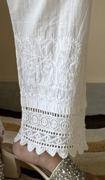 Chikankari at the hem of the white cotton pant, close up