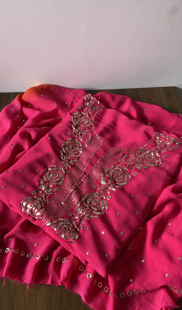 Pink viscose georgette kurta piece folded, badla work with rose motifs
