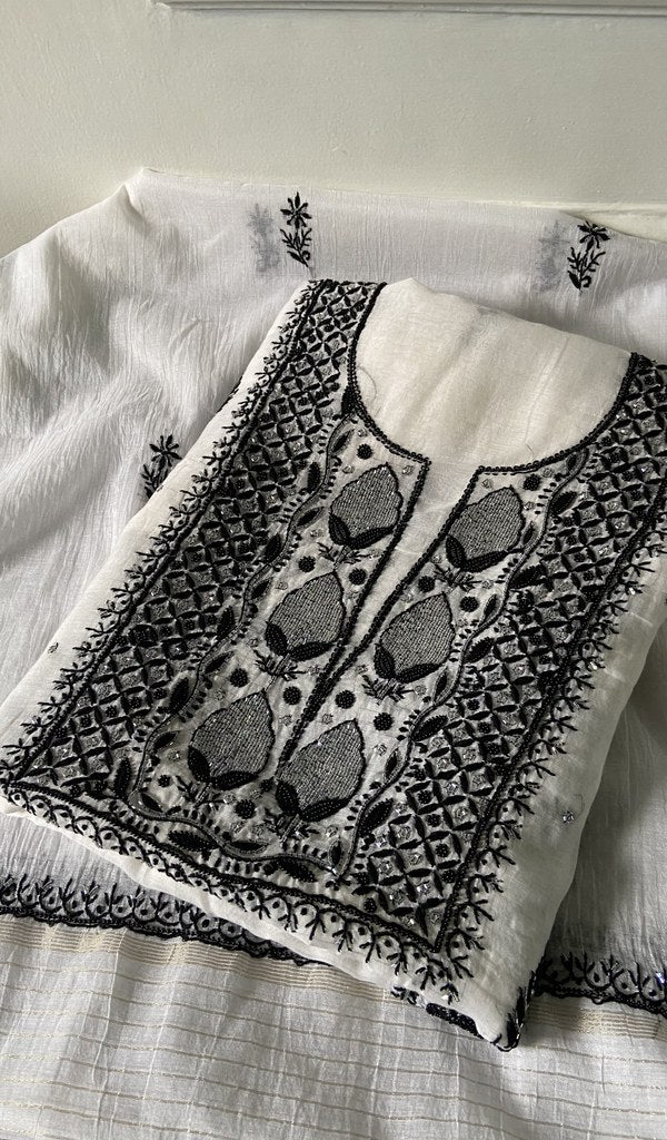 white chikankari set folded, worked panel on top