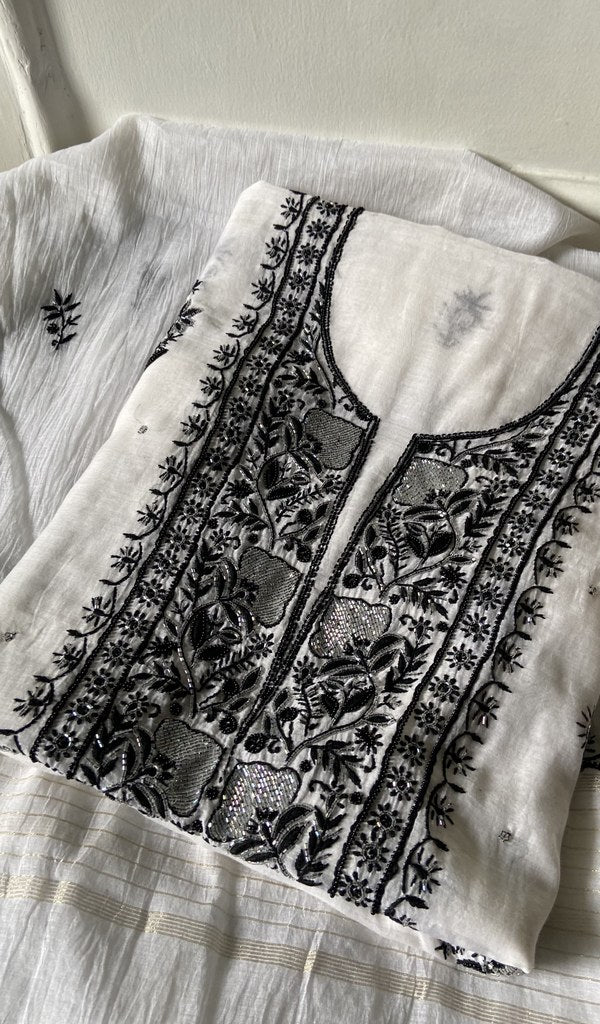white pure mul chanderi kurta piece folded, fine chikankari with beads cutdana and sequins