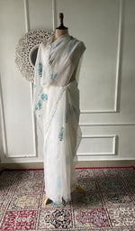 off white pure organza silk chikankari saree draped on the mannequin