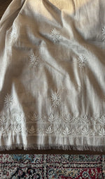 The beige kurta, spread out flat