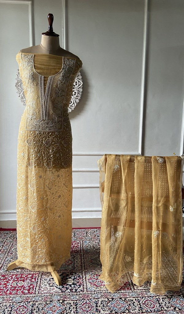 mustard pure organza silk chikankari set on the mannequin, dupatta on the stand