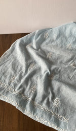 The kurta piece folded on the carpet
