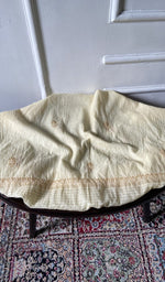 Chikankari across the body of the cream kurta piece