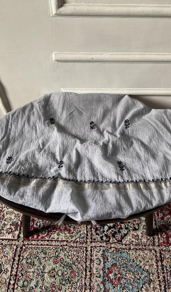 Chikankari across the body of the grey kurta piece
