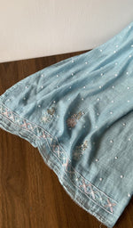 The kurta piece folded on the carpet