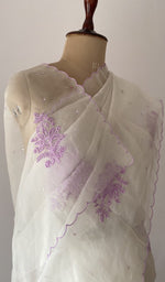 pallu of the off white saree, showing the do taar and teen taar chikankari
