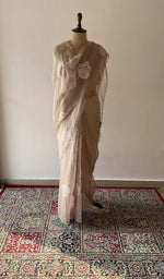 Beige pure organza silk saree draped on the mannequin