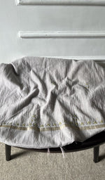 Bottom fabric draped over the stool