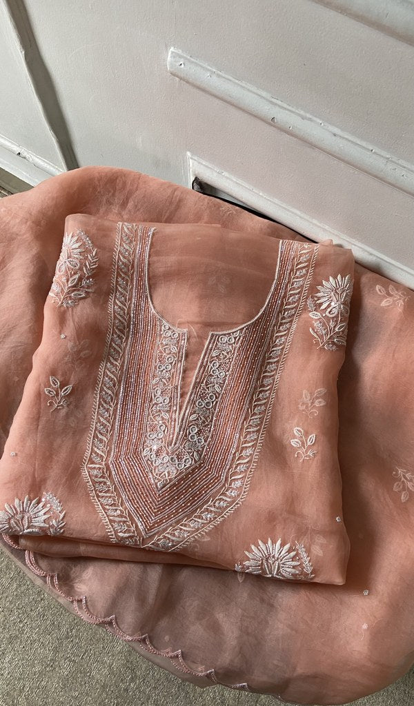 Peach pure organza silk kurta piece folded, do taar and teen taar chikankari