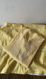 Folded yellow pure mul chanderi kurta piece with chikankari on the panel
