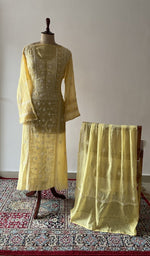 Yellow pure mul chanderi chikankari suit set on the mannequin with its dupatta