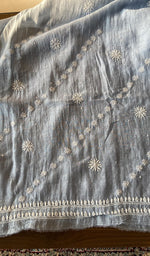 Powder blue mul chanderi laid out flat
