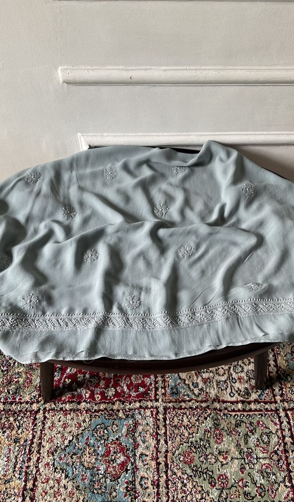 Chikankari across the body of the grey kurta piece