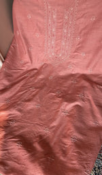 Salmon pink eri silk laid out flat