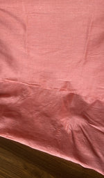 Close view of the salmon pink kurta fabric