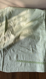 The sage green kurta, spread out flat