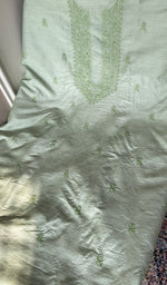 Sage green eri silk laid out flat