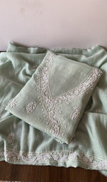 Folded green pure mul chanderi kurta piece with chikankari on the panel