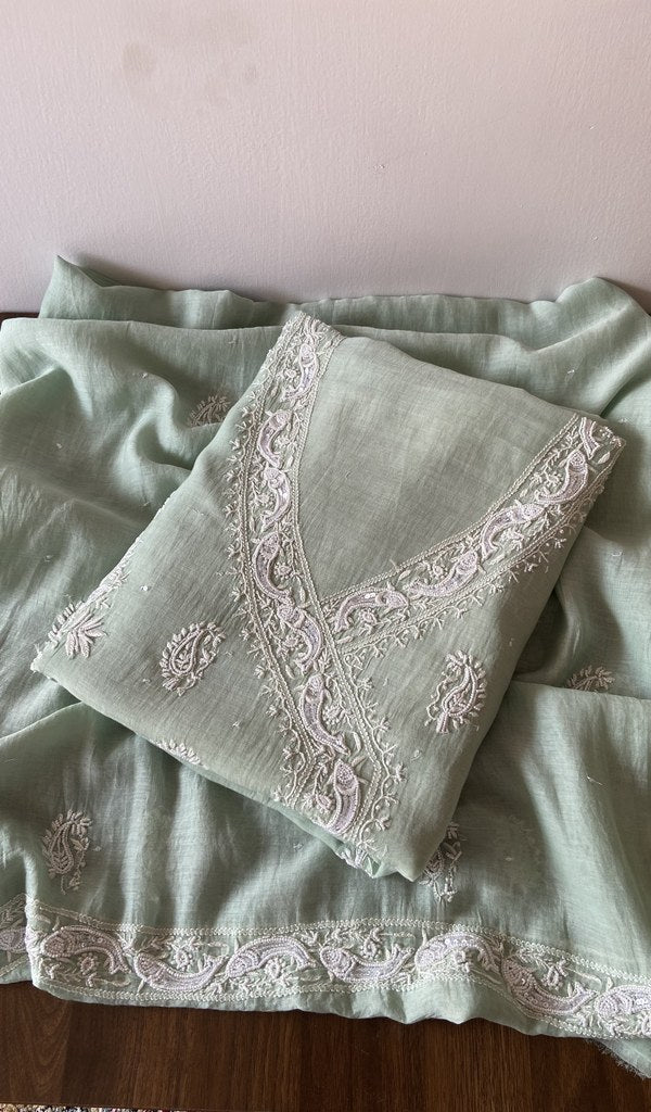 Folded green pure mul chanderi kurta piece with chikankari on the panel