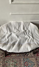 Chikankari across the body of the white kurta piece