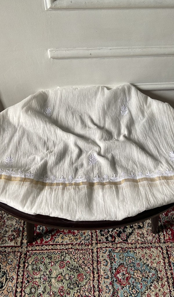 Chikankari across the body of the white kurta piece